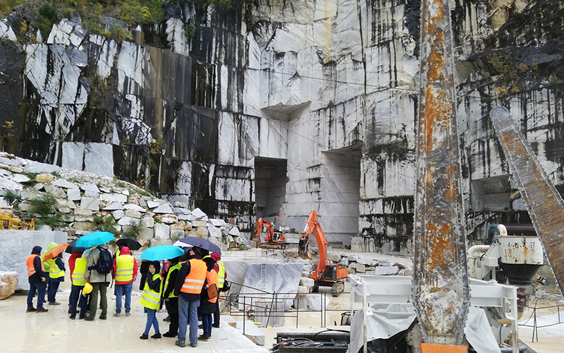 a group f tourist visiting an outdoor marble quarry