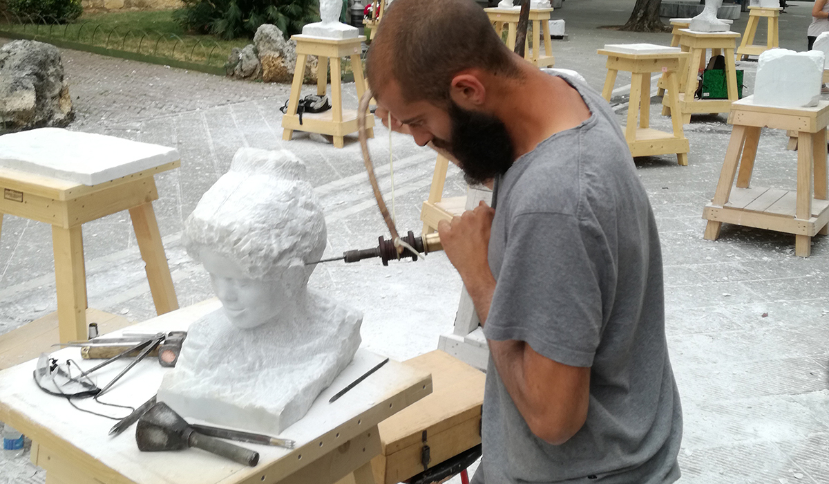 academy of fine arts student at sculpting with ancient tools