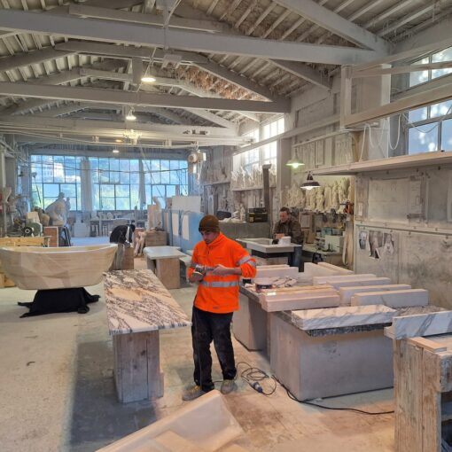 marble artisans at work in a carrara marble workshop of architects and designers